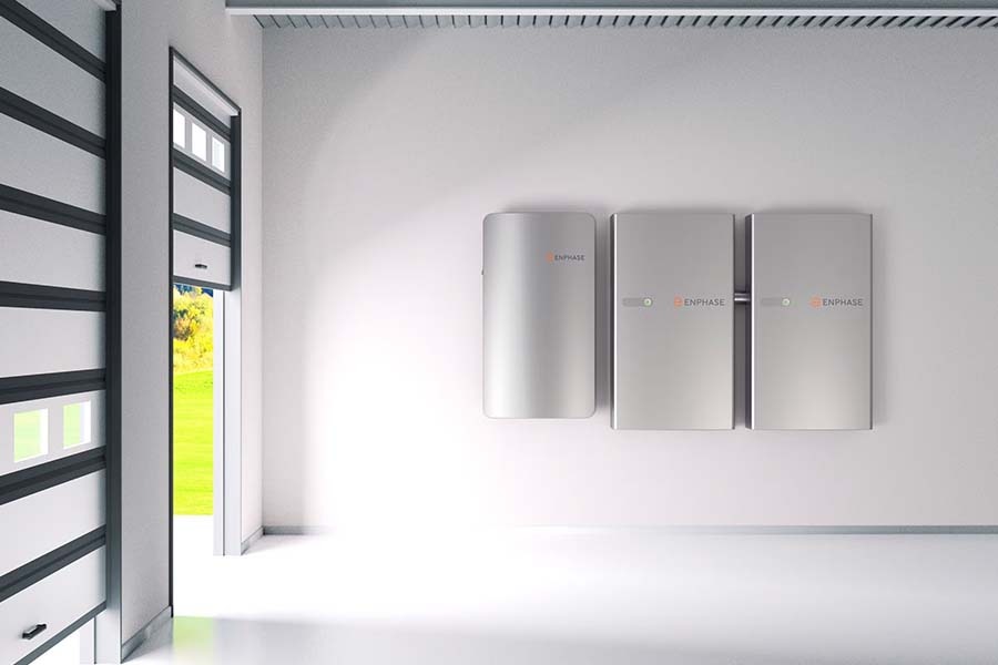 Enphase IQ Battery 10C — three silver wall-mounted units inside a clean modern garage